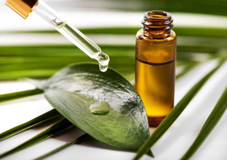 Tea Tree Oil is Poured by a Person on a Leaf