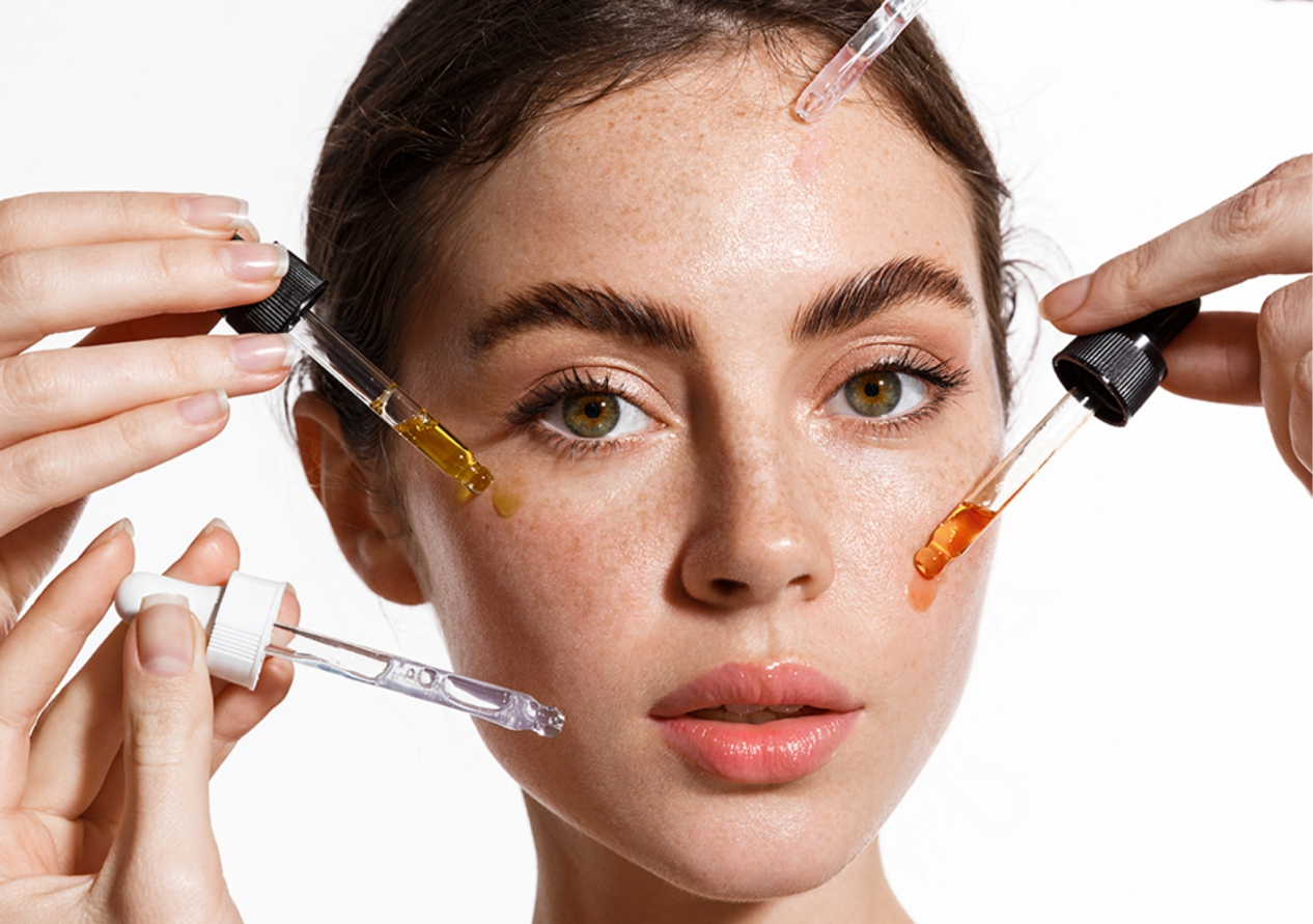 A Young Woman Pouring Some Serums on Her Face